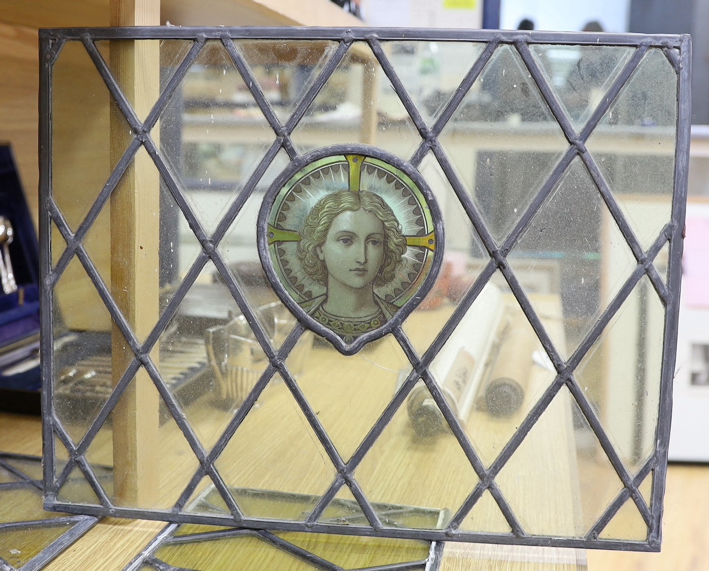 Four late 19th century leaded and stained glass panels, various sizes, with central cartouche 53cms wide x 41cms high